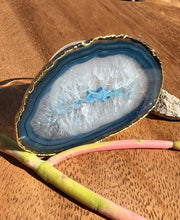 Blue Agate pop socket (popsocket) for use with iphone, androids, ipads, smartphones, and other small tecnical devices. Used for easy grip of electronics as well as a beautiful phone accessory. It is an attachment that easily tapes onto the back of the device and pops in and out as needed for use. These agate slices are natural and pure agate stones imported from Brazil of the highest quality and beautifylly gold dipped on the rim.