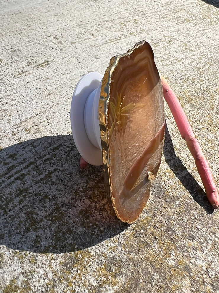 Brown Agate pop socket (popsocket) for use with iphone, androids, ipads, smartphones, and other small tecnical devices. Used for easy grip of electronics as well as a beautiful phone accessory. It is an attachment that easily tapes onto the back of the device and pops in and out as needed for use. These agate slices are natural and pure agate stones imported from Brazil of the highest quality and beautifylly gold dipped on the rim.