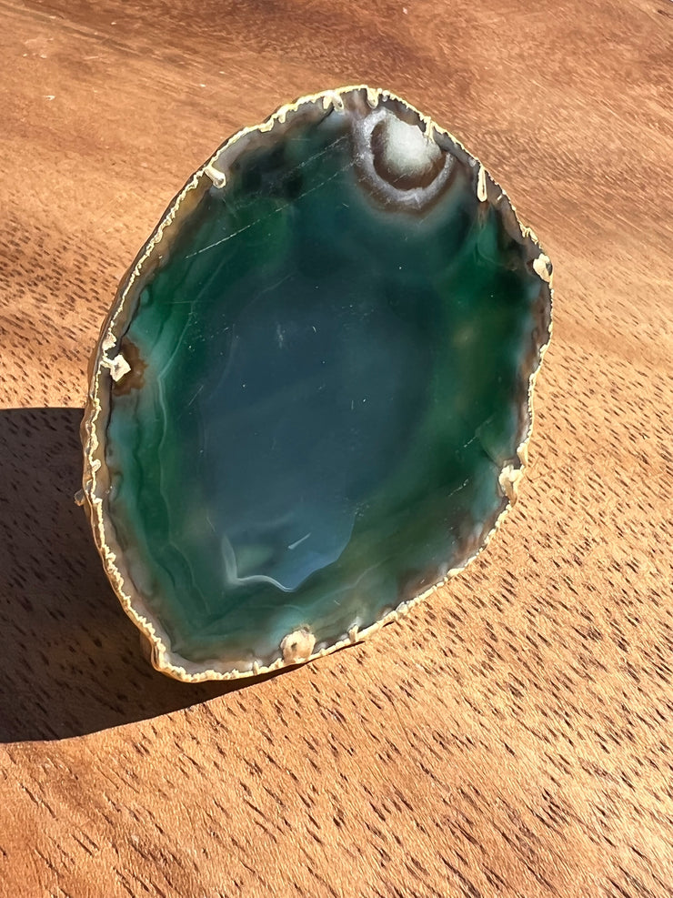Green Agate pop socket (popsocket) for use with iphone, androids, ipads, smartphones and other small tecnical devices. Used for easy grip of electronics as well as a beautiful phone accessory. It is an attachment that easily tapes onto the back of the device and pops in and out as needed for use. These agate slices are natural and pure agate stones imported from Brazil of the highest quality and beautifylly gold dipped on the rim.