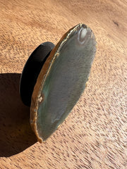 Green Agate pop socket (popsocket) for use with iphone, androids, ipads, smartphones and other small tecnical devices. Used for easy grip of electronics as well as a beautiful phone accessory. It is an attachment that easily tapes onto the back of the device and pops in and out as needed for use. These agate slices are natural and pure agate stones imported from Brazil of the highest quality and beautifylly gold dipped on the rim.