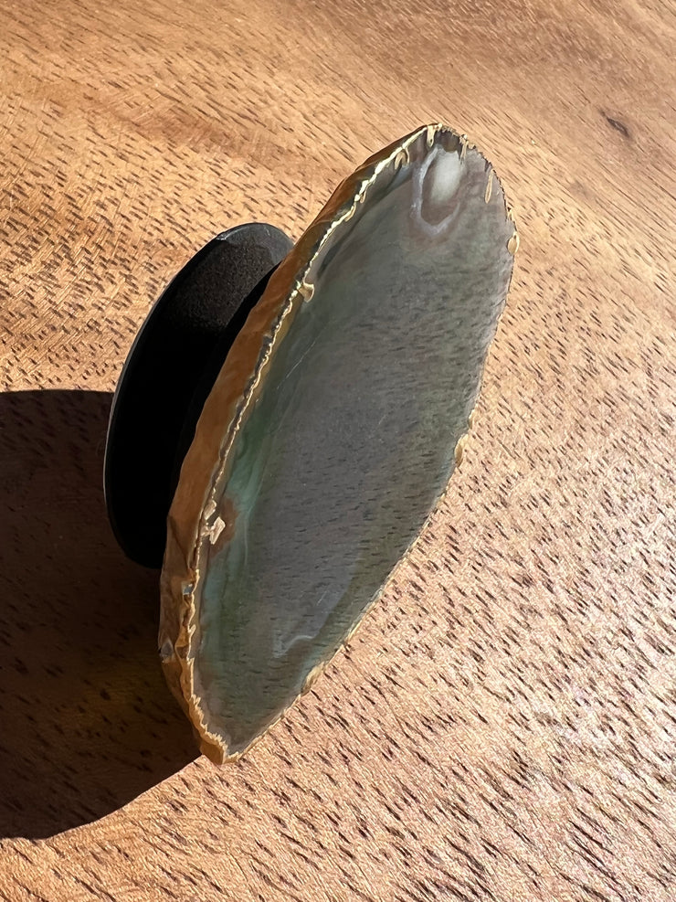 Green Agate pop socket (popsocket) for use with iphone, androids, ipads, smartphones and other small tecnical devices. Used for easy grip of electronics as well as a beautiful phone accessory. It is an attachment that easily tapes onto the back of the device and pops in and out as needed for use. These agate slices are natural and pure agate stones imported from Brazil of the highest quality and beautifylly gold dipped on the rim.