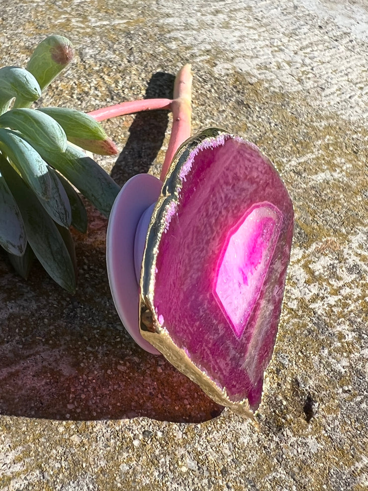 Pink Agate pop socket (popsocket) for use with iphone, androids, ipads, smartphones and other small tecnical devices. Used for easy grip of electronics as well as a beautiful phone accessory. It is an attachment that easily tapes onto the back of the device and pops in and out as needed for use. These agate slices are natural and pure agate stones imported from Brazil of the highest quality and beautifylly gold dipped on the rim.