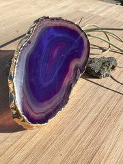 Purple Agate pop socket (popsocket) for use with iphone, androids, ipads, smartphones and other small tecnical devices. Used for easy grip of electronics as well as a beautiful phone accessory. It is an attachment that easily tapes onto the back of the device and pops in and out as needed for use. These agate slices are natural and pure agate stones imported from Brazil of the highest quality and beautifylly gold dipped on the rim.