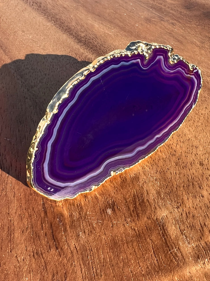 Purple Agate pop socket (popsocket) for use with iphone, androids, ipads, smartphones and other small tecnical devices. Used for easy grip of electronics as well as a beautiful phone accessory. It is an attachment that easily tapes onto the back of the device and pops in and out as needed for use. These agate slices are natural and pure agate stones imported from Brazil of the highest quality and beautifylly gold dipped on the rim.