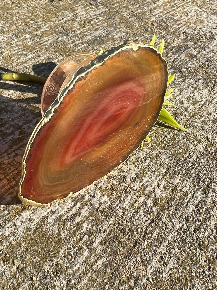 Red Agate pop socket (popsocket) for use with iphone, androids, ipads, smartphones and other small tecnical devices. Used for easy grip of electronics as well as a beautiful phone accessory. It is an attachment that easily tapes onto the back of the device and pops in and out as needed for use. These agate slices are natural and pure agate stones imported from Brazil of the highest quality and beautifylly gold dipped on the rim.