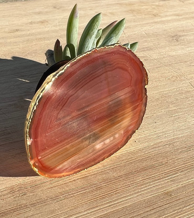 Red Agate pop socket (popsocket) for use with iphone, androids, ipads, smartphones and other small tecnical devices. Used for easy grip of electronics as well as a beautiful phone accessory. It is an attachment that easily tapes onto the back of the device and pops in and out as needed for use. These agate slices are natural and pure agate stones imported from Brazil of the highest quality and beautifylly gold dipped on the rim.