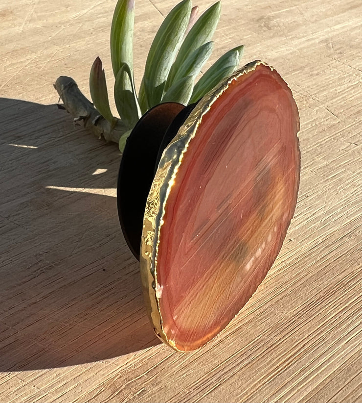 Red Agate pop socket (popsocket) for use with iphone, androids, ipads, smartphones and other small tecnical devices. Used for easy grip of electronics as well as a beautiful phone accessory. It is an attachment that easily tapes onto the back of the device and pops in and out as needed for use. These agate slices are natural and pure agate stones imported from Brazil of the highest quality and beautifylly gold dipped on the rim.