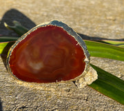 Red Agate pop socket (popsocket) for use with iphone, androids, ipads, smartphones and other small tecnical devices. Used for easy grip of electronics as well as a beautiful phone accessory. It is an attachment that easily tapes onto the back of the device and pops in and out as needed for use. These agate slices are natural and pure agate stones imported from Brazil of the highest quality and beautifylly gold dipped on the rim.