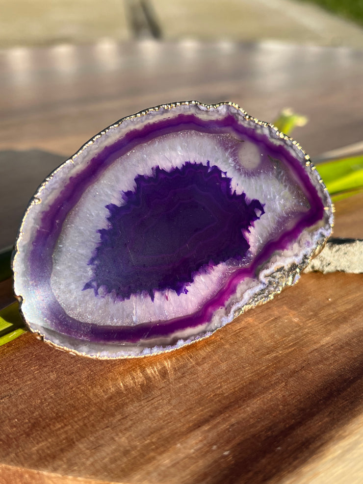 Purple Agate pop socket (popsocket) for use with iphone, androids, ipads, smartphones and other small tecnical devices. Used for easy grip of electronics as well as a beautiful phone accessory. It is an attachment that easily tapes onto the back of the device and pops in and out as needed for use. These agate slices are natural and pure agate stones imported from Brazil of the highest quality and beautifylly gold dipped on the rim.