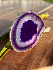 Purple Agate pop socket (popsocket) for use with iphone, androids, ipads, smartphones and other small tecnical devices. Used for easy grip of electronics as well as a beautiful phone accessory. It is an attachment that easily tapes onto the back of the device and pops in and out as needed for use. These agate slices are natural and pure agate stones imported from Brazil of the highest quality and beautifylly gold dipped on the rim.
