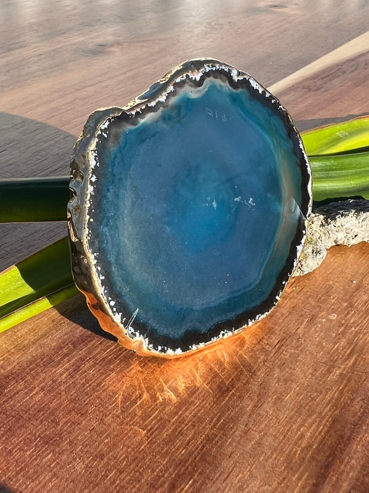 Blue Agate pop socket (popsocket) for use with iphone, androids, ipads, smartphones, and other small tecnical devices. Used for easy grip of electronics as well as a beautiful phone accessory. It is an attachment that easily tapes onto the back of the device and pops in and out as needed for use. These agate slices are natural and pure agate stones imported from Brazil of the highest quality and beautifylly gold dipped on the rim.