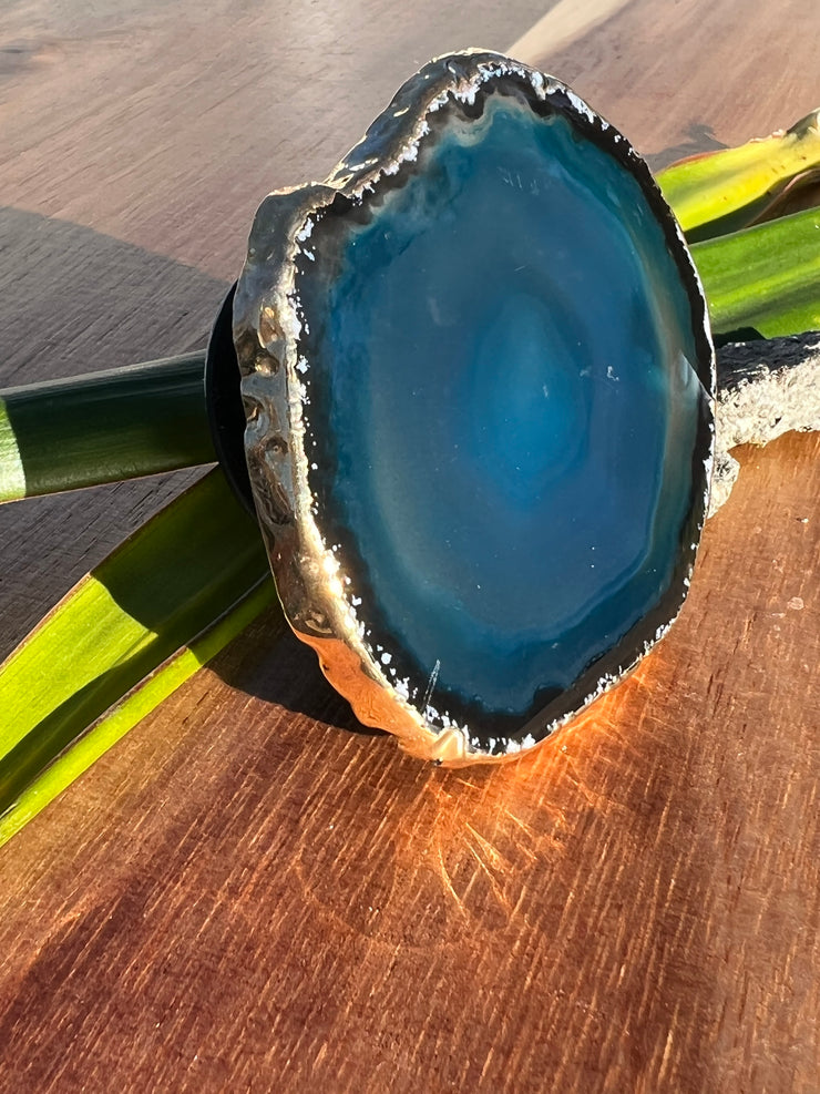 Blue Agate pop socket (popsocket) for use with iphone, androids, ipads, smartphones, and other small tecnical devices. Used for easy grip of electronics as well as a beautiful phone accessory. It is an attachment that easily tapes onto the back of the device and pops in and out as needed for use. These agate slices are natural and pure agate stones imported from Brazil of the highest quality and beautifylly gold dipped on the rim.