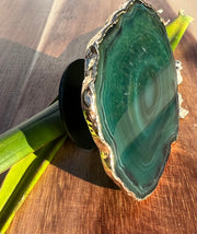 Green Agate pop socket (popsocket) for use with iphone, androids, ipads, smartphones and other small tecnical devices. Used for easy grip of electronics as well as a beautiful phone accessory. It is an attachment that easily tapes onto the back of the device and pops in and out as needed for use. These agate slices are natural and pure agate stones imported from Brazil of the highest quality and beautifylly gold dipped on the rim.