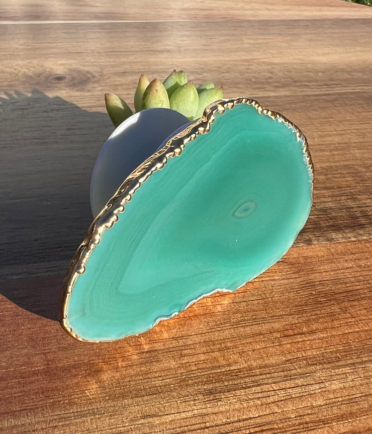 Green Agate pop socket (popsocket) for use with iphone, androids, ipads, smartphones and other small tecnical devices. Used for easy grip of electronics as well as a beautiful phone accessory. It is an attachment that easily tapes onto the back of the device and pops in and out as needed for use. These agate slices are natural and pure agate stones imported from Brazil of the highest quality and beautifylly gold dipped on the rim.