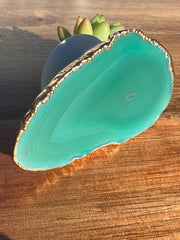 Green Agate pop socket (popsocket) for use with iphone, androids, ipads, smartphones and other small tecnical devices. Used for easy grip of electronics as well as a beautiful phone accessory. It is an attachment that easily tapes onto the back of the device and pops in and out as needed for use. These agate slices are natural and pure agate stones imported from Brazil of the highest quality and beautifylly gold dipped on the rim.