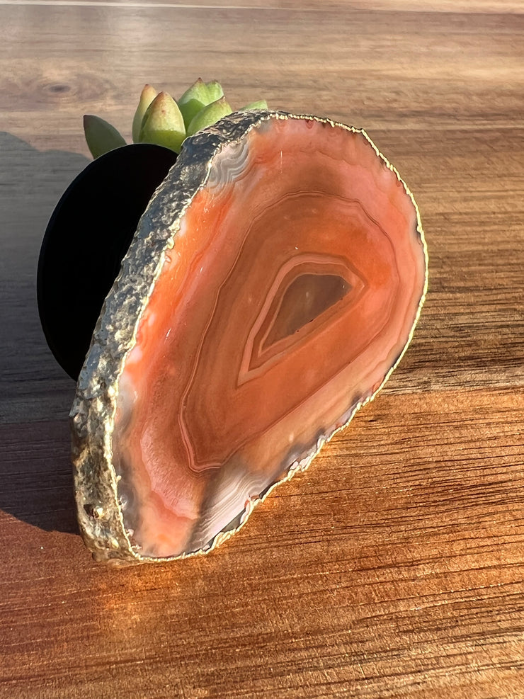 Red Agate pop socket (popsocket) for use with iphone, androids, ipads, smartphones and other small tecnical devices. Used for easy grip of electronics as well as a beautiful phone accessory. It is an attachment that easily tapes onto the back of the device and pops in and out as needed for use. These agate slices are natural and pure agate stones imported from Brazil of the highest quality and beautifylly gold dipped on the rim.