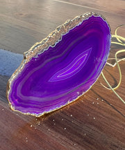 Purple Agate pop socket (popsocket) for use with iphone, androids, ipads, smartphones and other small tecnical devices. Used for easy grip of electronics as well as a beautiful phone accessory. It is an attachment that easily tapes onto the back of the device and pops in and out as needed for use. These agate slices are natural and pure agate stones imported from Brazil of the highest quality and beautifylly gold dipped on the rim.