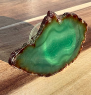Green Agate pop socket (popsocket) for use with iphone, androids, ipads, smartphones and other small tecnical devices. Used for easy grip of electronics as well as a beautiful phone accessory. It is an attachment that easily tapes onto the back of the device and pops in and out as needed for use. These agate slices are natural and pure agate stones imported from Brazil of the highest quality with it's natural edges exposed.