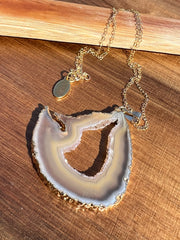 Natural Agate slice druzy necklace pendant, gold rimmed. Varies in hues, size, shape and tones. Comes with durable 14k gold filled chain length 16inches (41cm) and Elemant logo tag in gold attached by the clasp. Beautifully crafted natural agate stones in highest quality imported from Brazil.