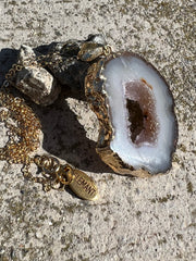Natural Agate slice druzy necklace pendant, gold rimmed. Varies in hues, size, shape and tones. Comes with durable 14k gold filled chain length 16inches (41cm) and Elemant logo tag in gold attached by the clasp. Beautifully crafted natural agate stones in highest quality imported from Brazil.