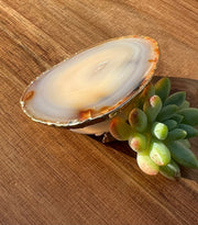 White Agate pop socket (popsocket) for use with iphone, androids, ipads, smartphones and other small tecnical devices. Used for easy grip of electronics as well as a beautiful phone accessory. It is an attachment that easily tapes onto the back of the device and pops in and out as needed for use. These agate slices are natural and pure agate stones imported from Brazil of the highest quality and beautifylly gold dipped on the rim.
