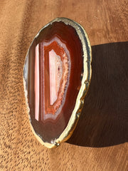 Red Agate pop socket (popsocket) for use with iphone, androids, ipads, smartphones and other small tecnical devices. Used for easy grip of electronics as well as a beautiful phone accessory. It is an attachment that easily tapes onto the back of the device and pops in and out as needed for use. These agate slices are natural and pure agate stones imported from Brazil of the highest quality and beautifylly gold dipped on the rim.