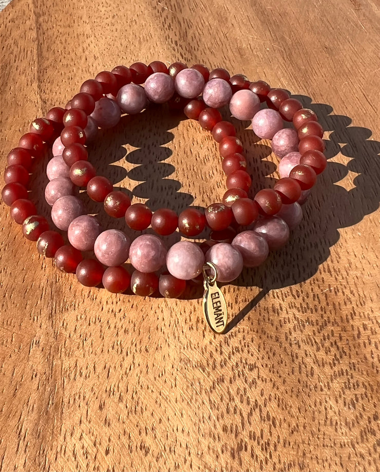 Lightly gold speckled natural Carnelian and Lepidotite bracelet in three stretchy strings and one Elemant gold emblem attached. All three stings come detached from one another for easy wear and comfort.