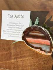 Red Agate pop socket (popsocket) for use with iphone, androids, ipads, smartphones and other small tecnical devices. Used for easy grip of electronics as well as a beautiful phone accessory. It is an attachment that easily tapes onto the back of the device and pops in and out as needed for use. These agate slices are natural and pure agate stones imported from Brazil of the highest quality and beautifylly gold dipped on the rim.  A note of the stones meaning and benefits are included in each box.