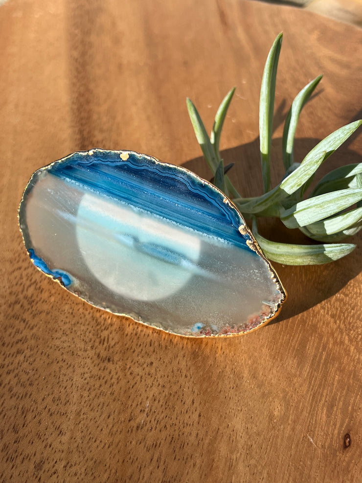 Blue Agate pop socket (popsocket) for use with iphone, androids, ipads, smartphones, and other small tecnical devices. Used for easy grip of electronics as well as a beautiful phone accessory. It is an attachment that easily tapes onto the back of the device and pops in and out as needed for use. These agate slices are natural and pure agate stones imported from Brazil of the highest quality and beautifylly gold dipped on the rim.