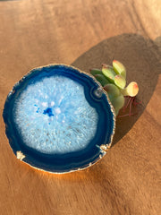 Blue Agate pop socket (popsocket) for use with iphone, androids, ipads, smartphones, and other small tecnical devices. Used for easy grip of electronics as well as a beautiful phone accessory. It is an attachment that easily tapes onto the back of the device and pops in and out as needed for use. These agate slices are natural and pure agate stones imported from Brazil of the highest quality and beautifylly gold dipped on the rim.