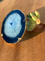 Blue Agate pop socket (popsocket) for use with iphone, androids, ipads, smartphones, and other small tecnical devices. Used for easy grip of electronics as well as a beautiful phone accessory. It is an attachment that easily tapes onto the back of the device and pops in and out as needed for use. These agate slices are natural and pure agate stones imported from Brazil of the highest quality and beautifylly gold dipped on the rim.