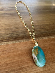 Opal pendant with 17.5 inch (44.5cm) oval chain linked 14k gold filled chain and a gold Elemant logo emblem attached at the clasp. Opal is the stone of abundance, fortune, luck, health and wealth.Opal pendant with 17.5 inch (44.5cm) oval chain linked 14k gold filled chain and a gold Elemant logo emblem attached at the clasp. Opal is the stone of abundance, fortune, luck, health and wealth.