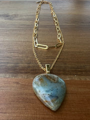 Opal pendant with layered 14k gold filled chains. An oval long chained link and a thinner longer gold chain that the Opal hangs from. A gold Elemant logo emblem is attached at the clasp. Opal is the stone of abundance, fortune, luck, health and wealth.