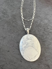 Opal necklace pendant on double sterling silver chains and a small Elemant logo attached at the clasp.