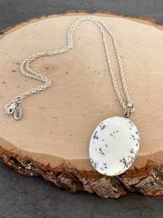 Opal necklace pendant on a long roped sterling silver chain and a small Elemant logo attached at the clasp.