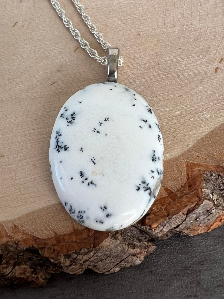 Opal necklace pendant on a long roped sterling silver chain and a small Elemant logo attached at the clasp.