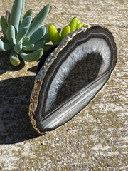 Black Agate pop socket (popsocket) for use with iphone, androids, ipads, and other small tecnical devices. Used for easy grip of electronics as well as a beautiful phone accessory. It is an attachment that easily tapes onto the back of the device and pops in and out as needed for use. These agate slices are natural and pure agate stones imported from Brazil of the highest quality and beautifylly gold dipped on the rim.