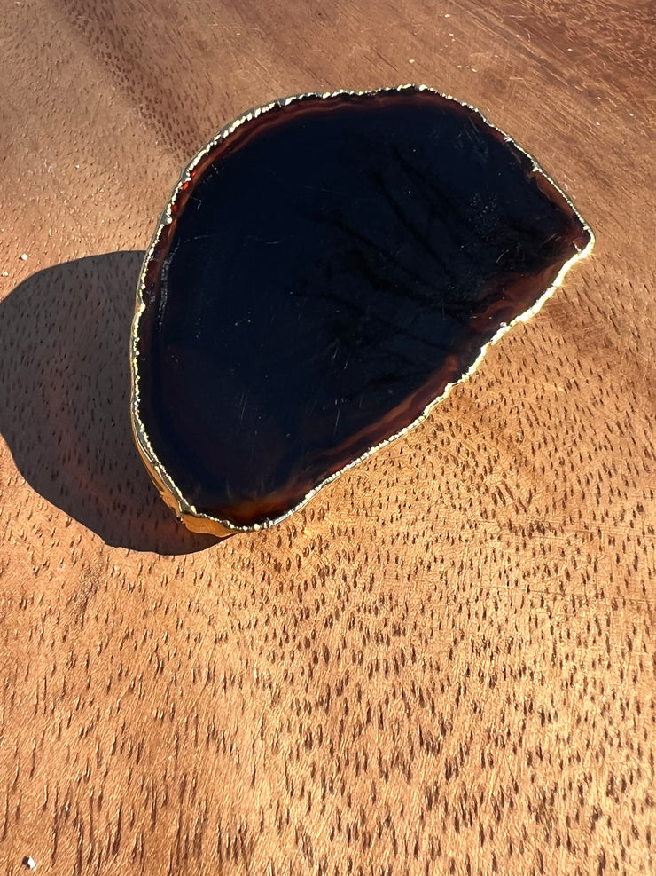 Black Agate pop socket (popsocket) for use with iphone, androids, ipads, and other small tecnical devices. Used for easy grip of electronics as well as a beautiful phone accessory. It is an attachment that easily tapes onto the back of the device and pops in and out as needed for use. These agate slices are natural and pure agate stones imported from Brazil of the highest quality and beautifylly gold dipped on the rim.