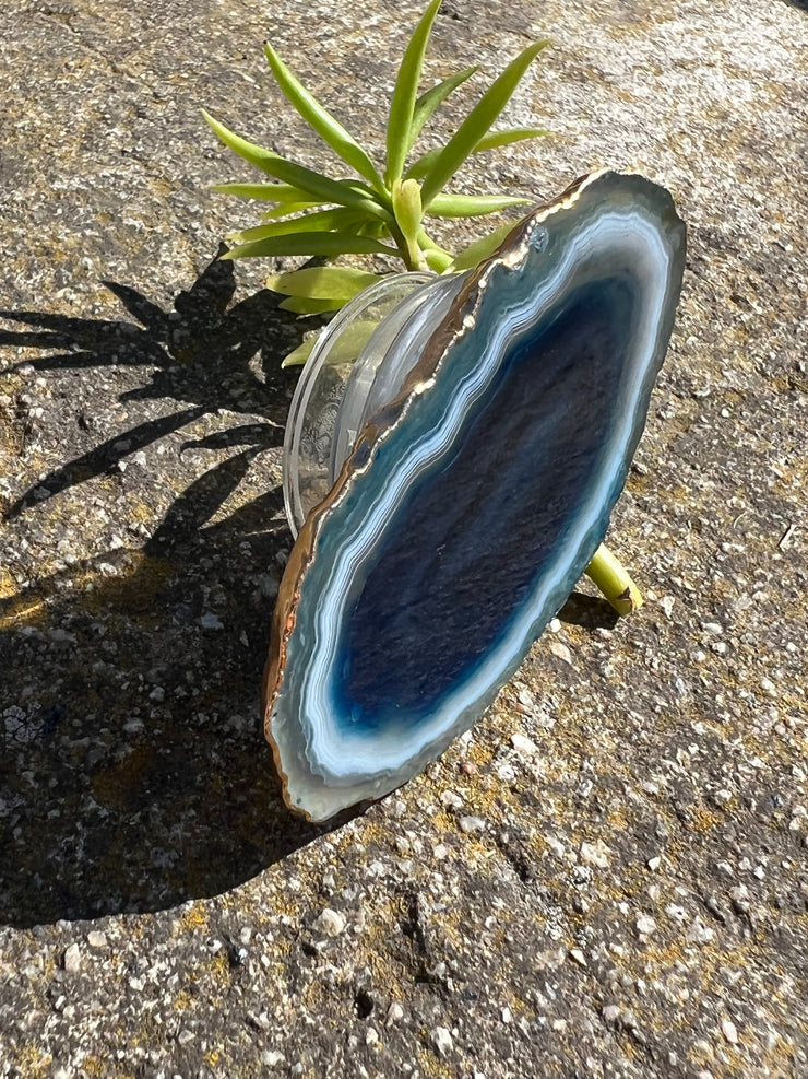 Blue Agate pop socket (popsocket) for use with iphone, androids, ipads, smartphones, and other small tecnical devices. Used for easy grip of electronics as well as a beautiful phone accessory. It is an attachment that easily tapes onto the back of the device and pops in and out as needed for use. These agate slices are natural and pure agate stones imported from Brazil of the highest quality and beautifylly gold dipped on the rim.