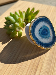 Blue Agate pop socket (popsocket) for use with iphone, androids, ipads, smartphones, and other small tecnical devices. Used for easy grip of electronics as well as a beautiful phone accessory. It is an attachment that easily tapes onto the back of the device and pops in and out as needed for use. These agate slices are natural and pure agate stones imported from Brazil of the highest quality and beautifylly gold dipped on the rim.